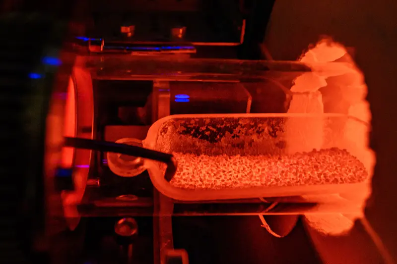The incinerator used in Kyle Doudricks lab, bright orange from heat.