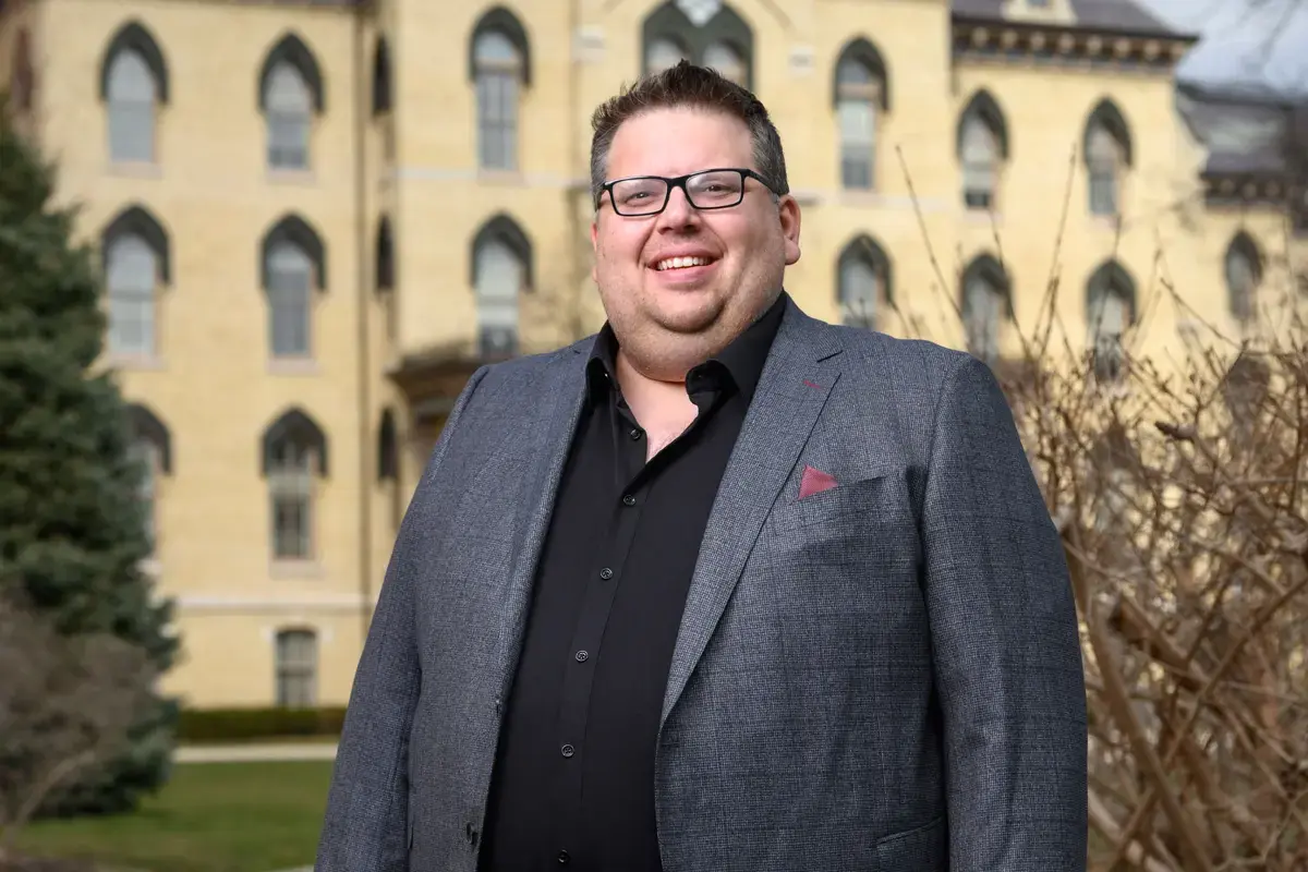 A portrait of Jeff Rhoads standing in front of the Notre Dame Administration building