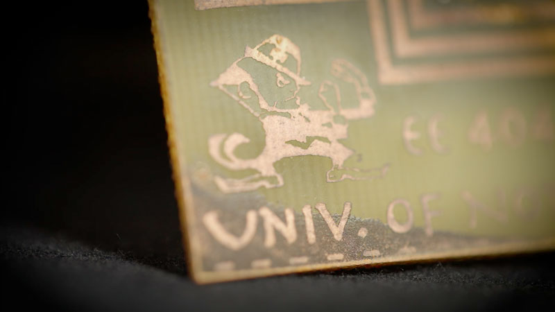 A video of a microchip etched with a leprechaun playing the Notre Dame fight song.